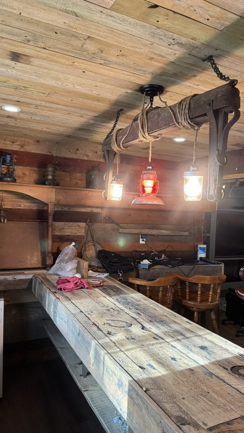 Custom bar light built from an antique horse-wagon frame